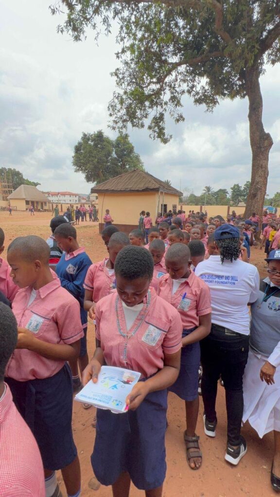 YDASS Foundation Members Donating Exercise Books and Writing Pens to the Students